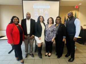 Panelists from left to right are Brondalyn Clark, Larry Nelson, Ursula Arlauskas, Tanisha Harris, Sesany Fennie-Jones, and moderator Michael Jones of the Vancouver Housing Authority.