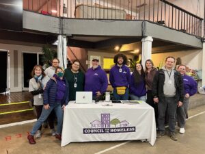 At Project Homeless Connect 2025, Council for the Homeless staff gather before the event's start to show their excitement. 